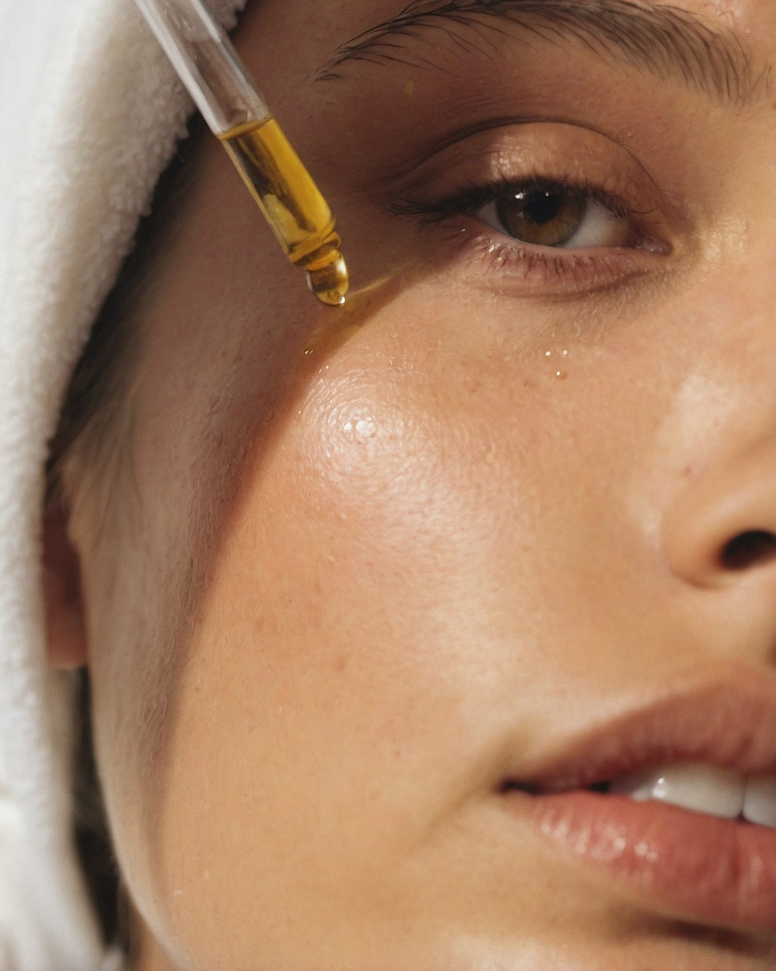 Facial oil being applied with a dropper during a treatment